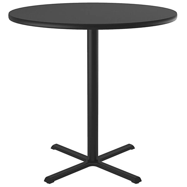 A black round Correll bar height table with a metal leg.