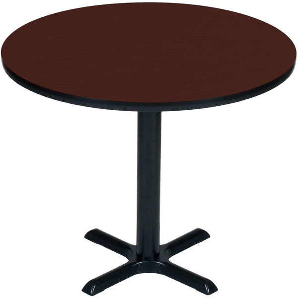 A Correll round table with a cherry finish top and black base.