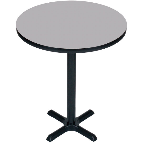 A Correll round bar height table with a gray granite finish top and black base.