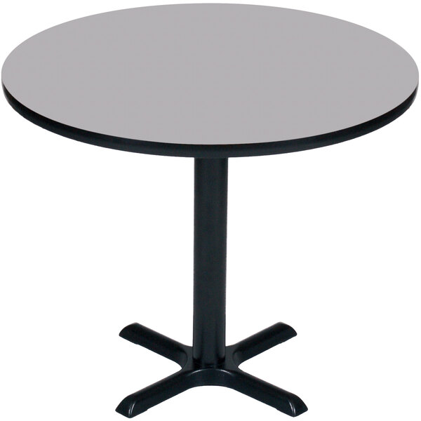 A Correll round bar height table with a grey granite top and a black base.