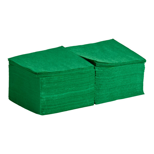 A stack of green 2-ply beverage or cocktail napkins.