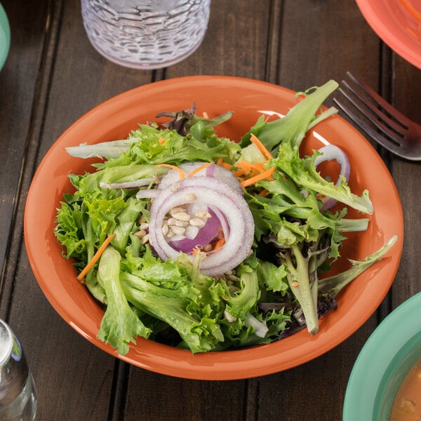 A salad in a GET Diamond Harvest pumpkin melamine bowl.