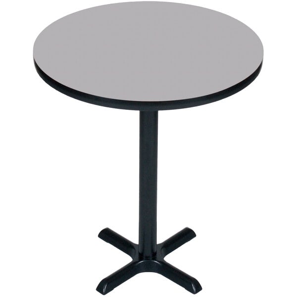 A Correll round bar height table with a gray granite top and black base.