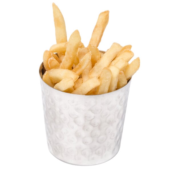 A container of french fries in a stainless steel hammered metal cup.