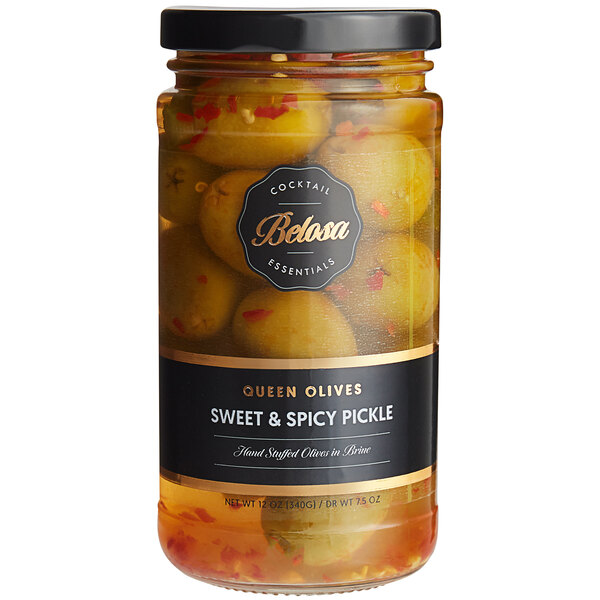 A jar of Belosa Sweet & Spicy Pickle Stuffed Queen Olives with a black label.