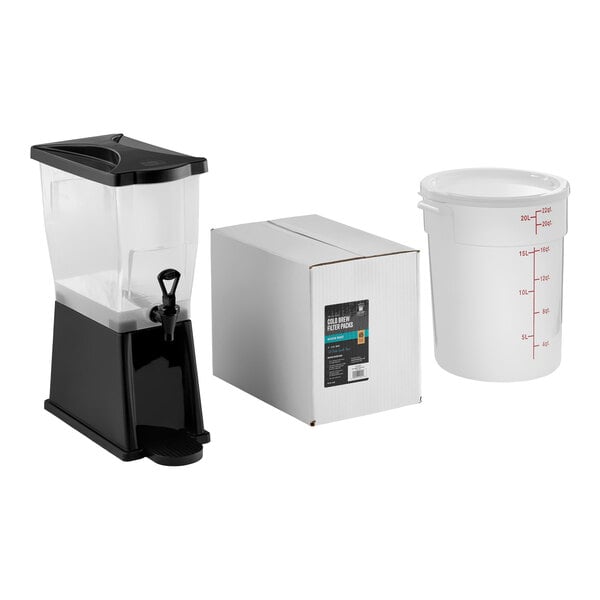 A cold brew system set including a beverage dispenser, a box of coffee filter packs, and a large plastic container with measurement markings.