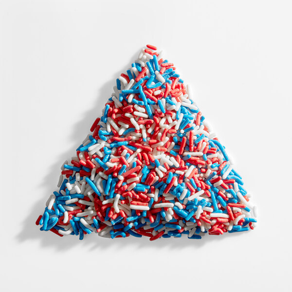 A pile of red, white, and blue sprinkles arranged in a triangle shape.