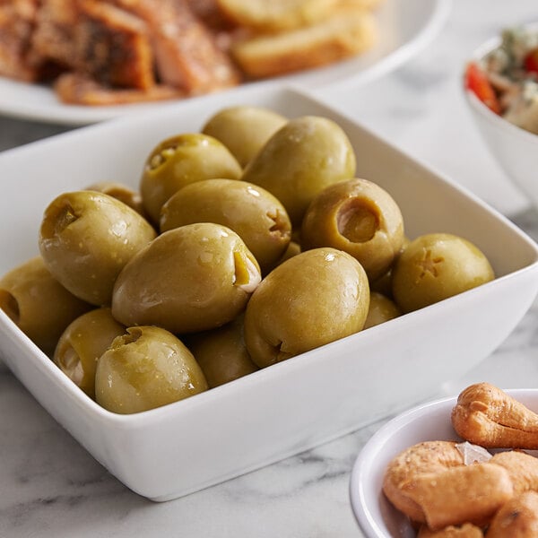 A bowl of Belosa blue cheese and jalapeno stuffed green olives on a table.