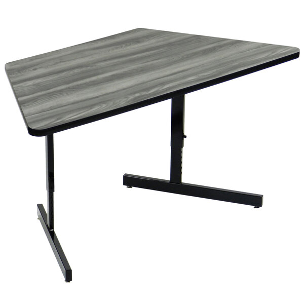 A New England Driftwood Correll trapezoid computer table with a black base.