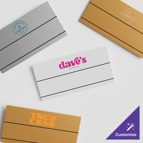 A white box of custom Cawley gold plastic rectangle nametags.