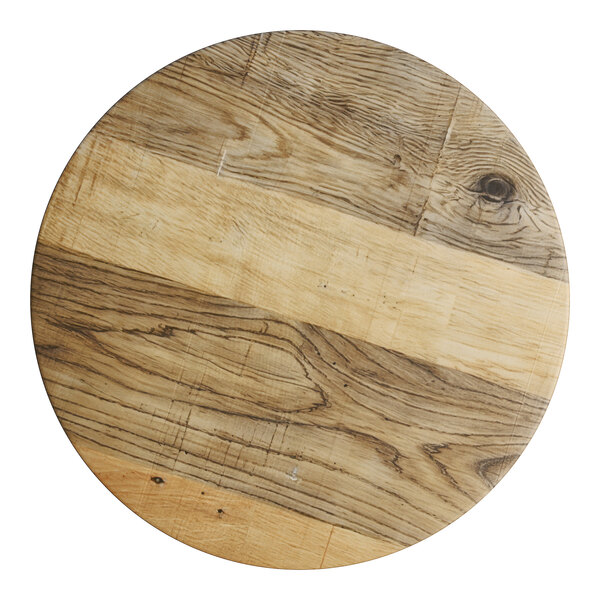 A Lancaster Table & Seating bar stool with a driftwood seat on a table in a farm-to-table restaurant.