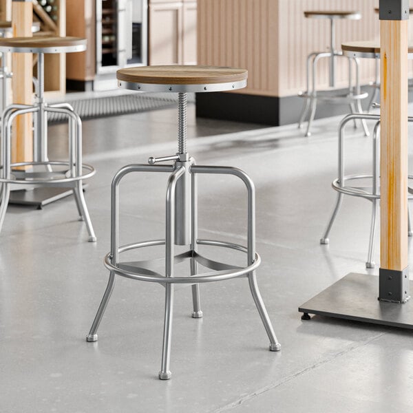 Lancaster Table & Seating metal bar stools with driftwood seats.