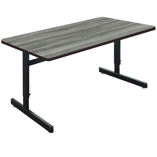 A Correll rectangular computer table with a New England Driftwood top and black frame.