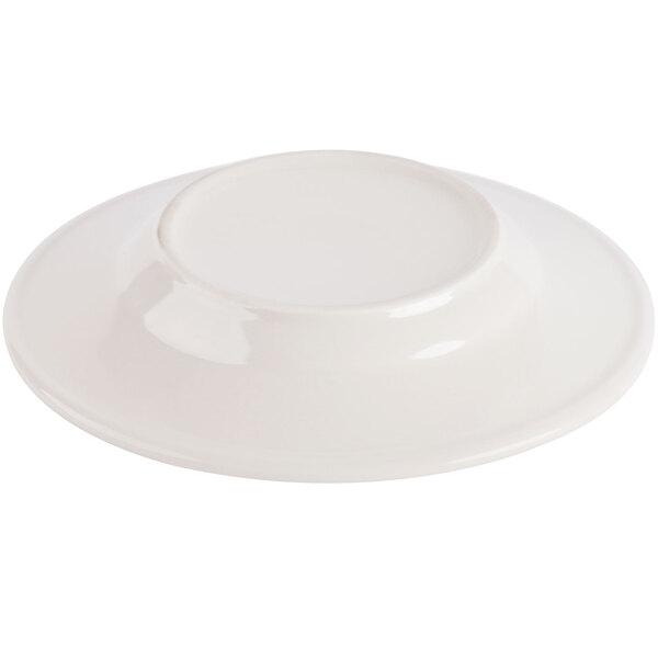 A close-up of a 7" ivory (American white) china bread and butter plate with an embossed rim.