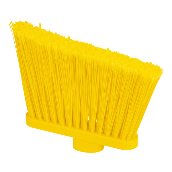 A close-up of a yellow broom with long bristles and a white handle.