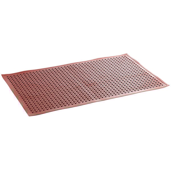 A close-up of a red rectangular rubber anti-fatigue floor mat with holes.