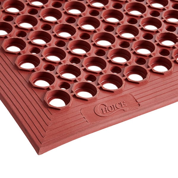 a red rubber mat with holes