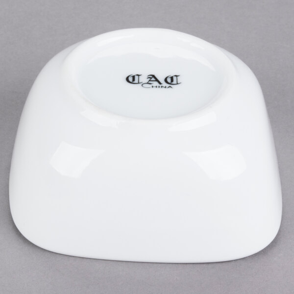 A white CAC Citysquare porcelain bowl with the black text "dad" on it.