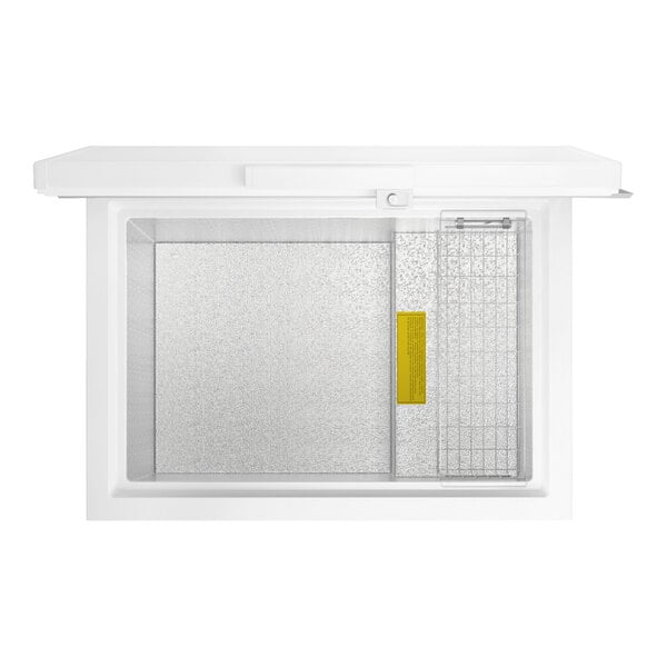 A white commercial chest freezer with a top-opening lid and an interior wire basket.