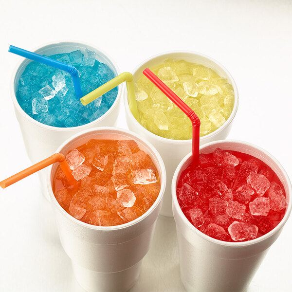 A group of cups with ice and straws next to a Hoshizaki Remote Condenser Ice Machine.