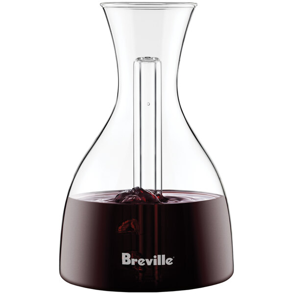 A Breville glass decanter filled with red liquid.