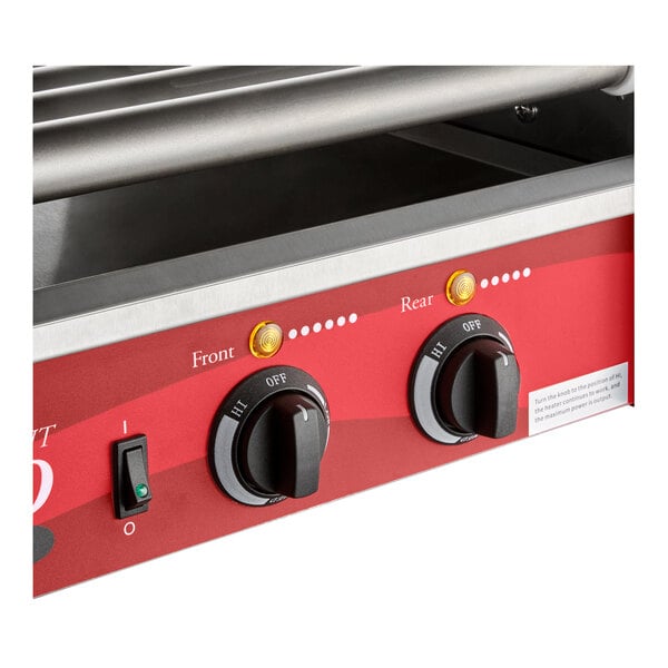 A close-up view of a red control panel with two black knobs labeled 'Front' and 'Rear,' indicator lights, and a power switch, beneath metal rollers.