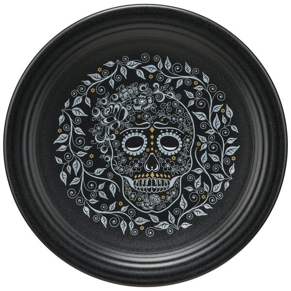 A black Fiesta plate with a skull and vine design.