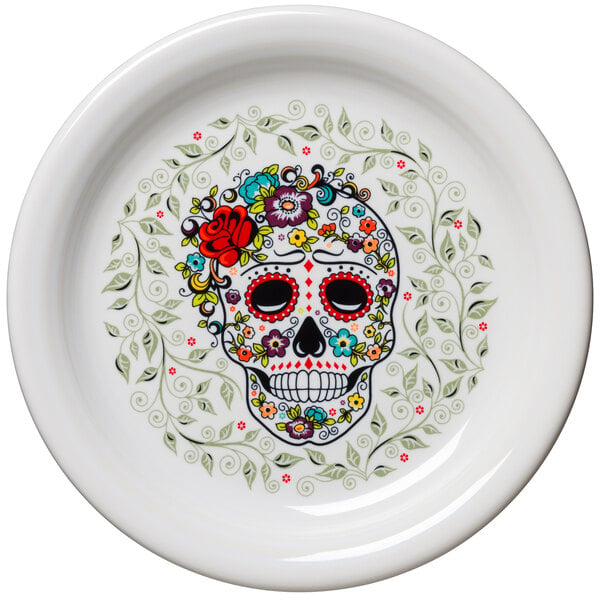 A white Fiesta bread and butter plate with a skull and vine design on it.