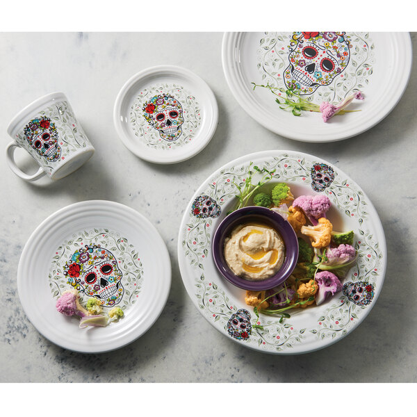 A white Fiesta ramekin with a skull and a flower on it.