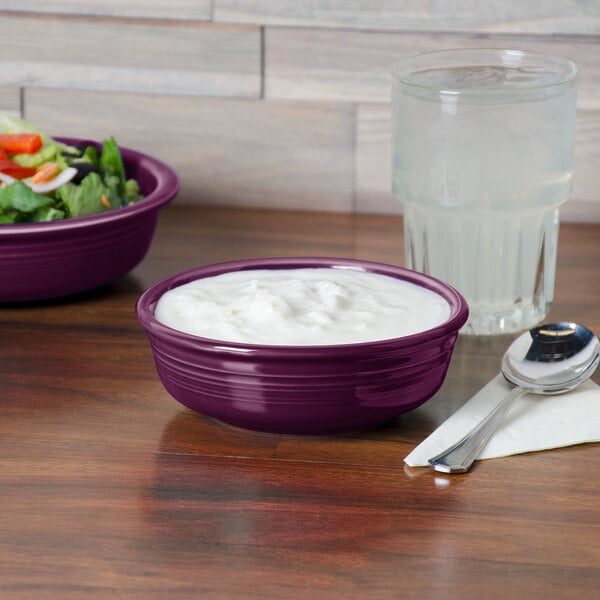 A purple Fiesta china bowl filled with white liquid.