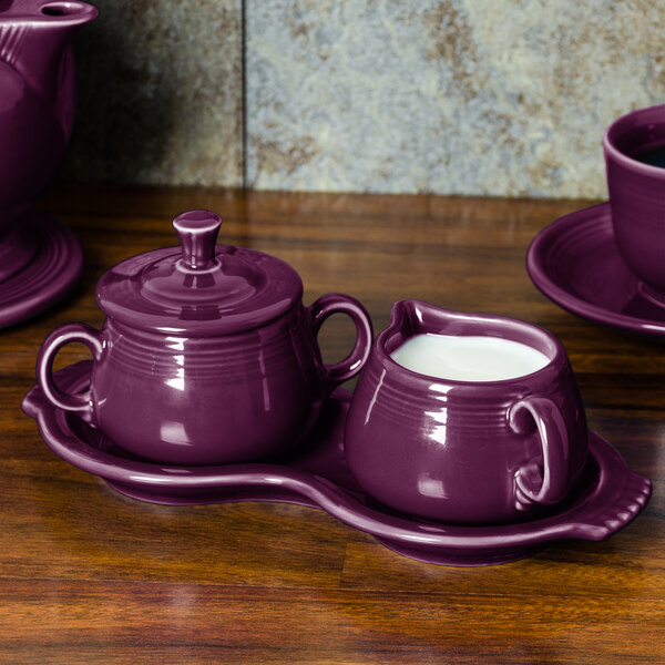 a purple ceramic tea set on a tray