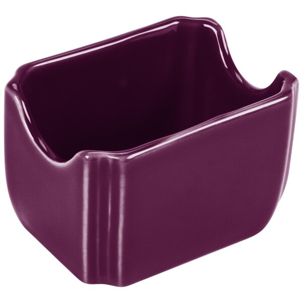A purple ceramic Fiesta sugar caddy with a handle.