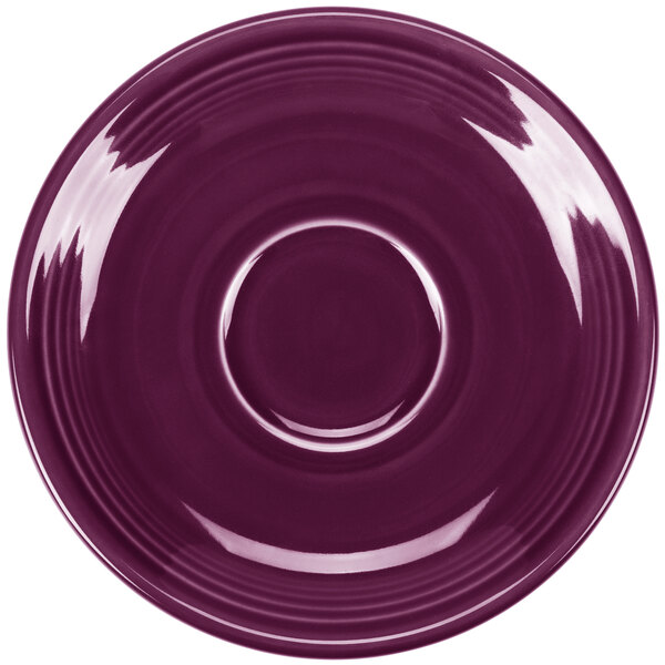 A mulberry Fiesta saucer with a rim and circle design.