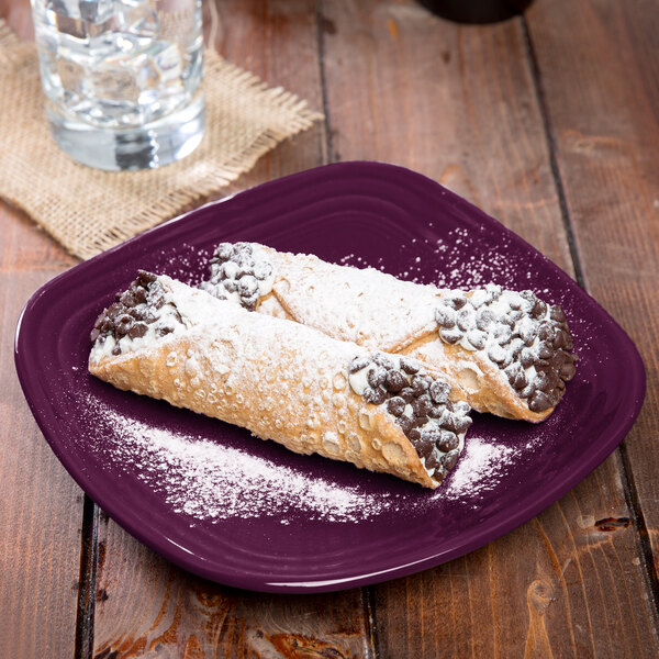 A Mulberry Fiesta® square salad plate with two pastries on it.