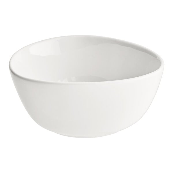 An Acopa Nova cream white stoneware bowl with a curved edge on a white background.
