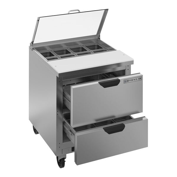 A Beverage-Air stainless steel refrigerated sandwich prep table with two drawers and clear lids.