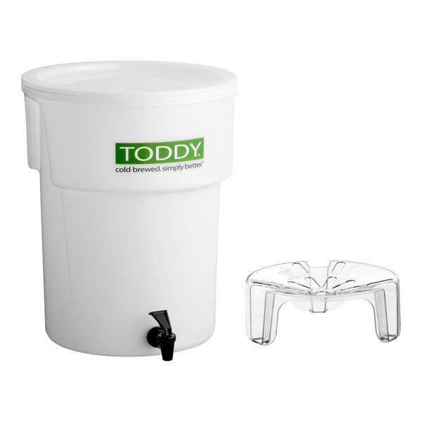 A white 5-gallon Toddy commercial cold brew system with a spigot and a separate plastic lift stand.