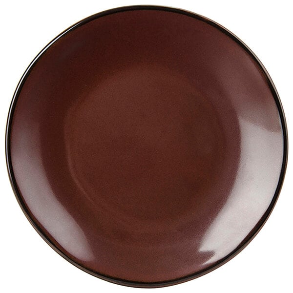 A brown Tuxton Artisan china plate with a black rim.