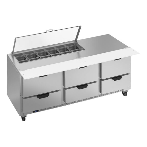 A Beverage-Air stainless steel sandwich prep table with six drawers on a large stainless steel counter.