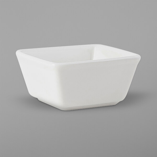 A Tuxton square ramekin in white china on a white background.