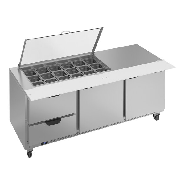 A Beverage-Air stainless steel refrigerated sandwich prep table with drawers and clear lids.