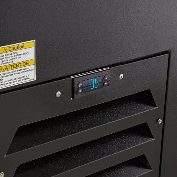 A black metal box with a digital display on a Beverage-Air bottle cooler.