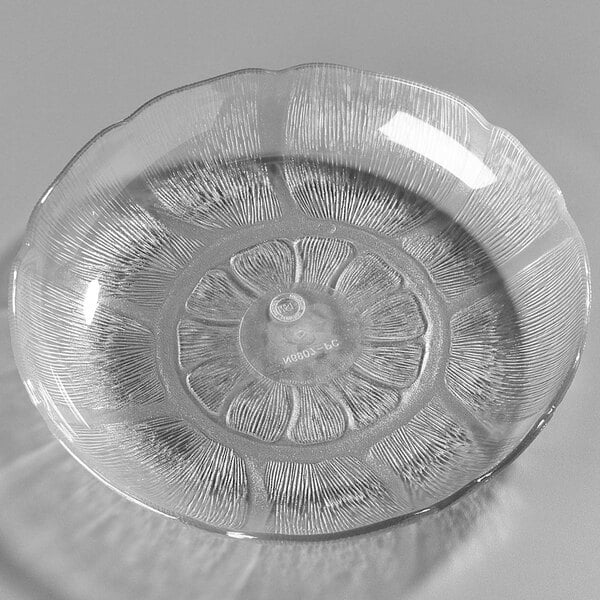A clear polycarbonate plate with a flower design.