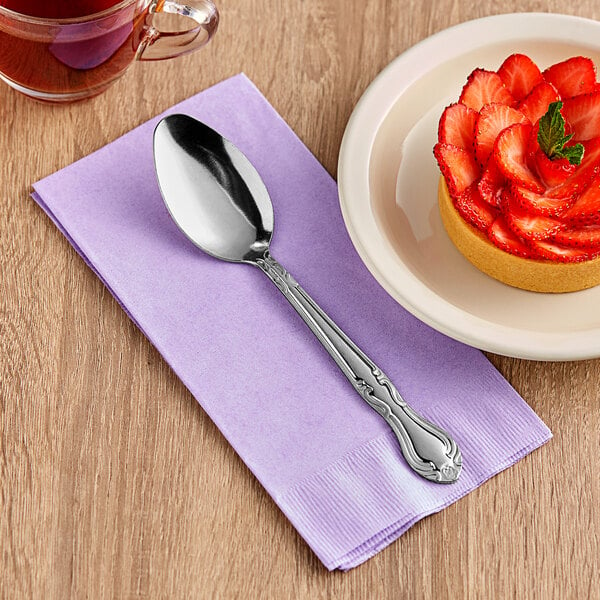 A dessert on a plate with a Choice stainless steel dinner/dessert spoon.