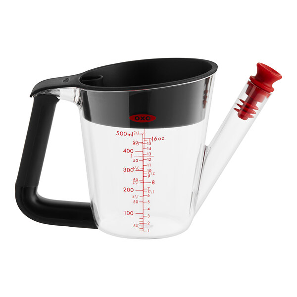 An OXO clear measuring cup with red writing and a black handle.
