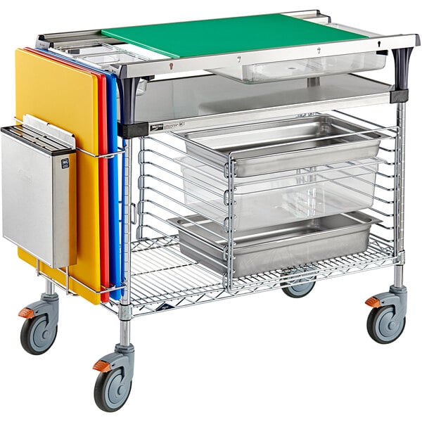 A Metro PrepMate vegetable prep cart with trays on wheels.
