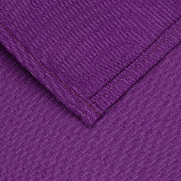 A purple hemmed square table cover with a stitch.