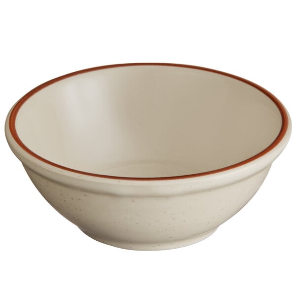 A white stoneware bowl with a brown and red narrow rim.