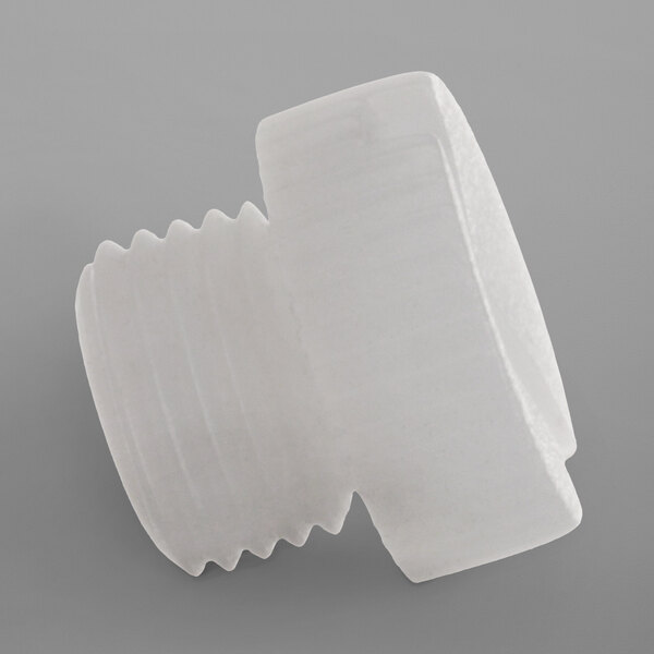 A white plastic plug for a Noble Warewashing rinse arm.