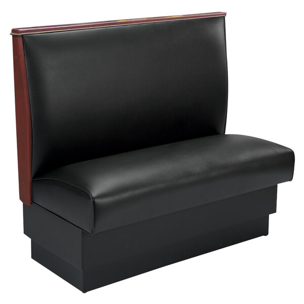 An American Tables & Seating black fully upholstered booth with wood end and top caps.